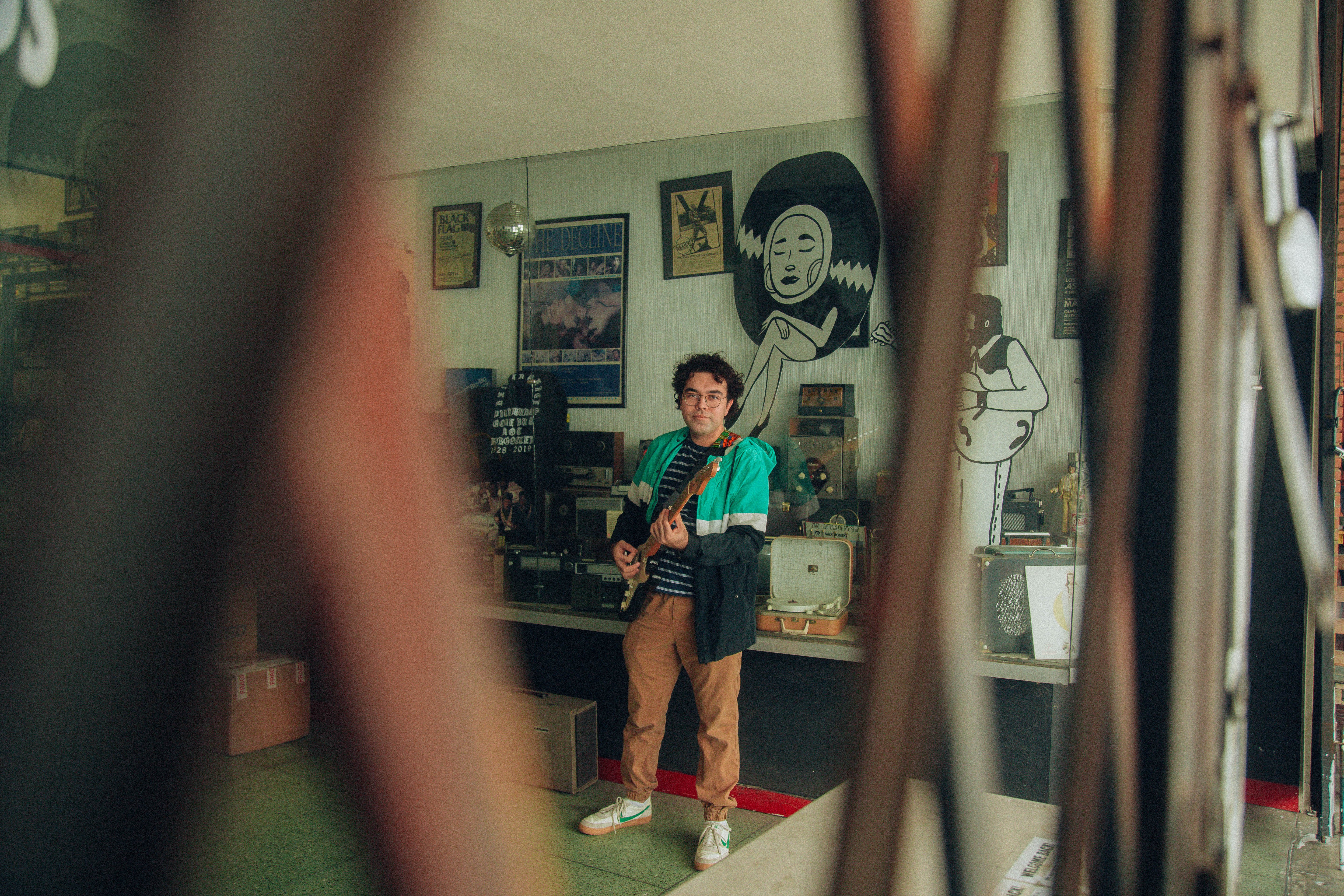 Lou Beauty plays guitar in his studio
